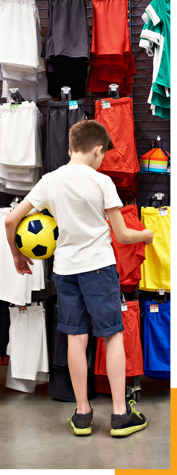 Boy holding a ball in a sporting goods store